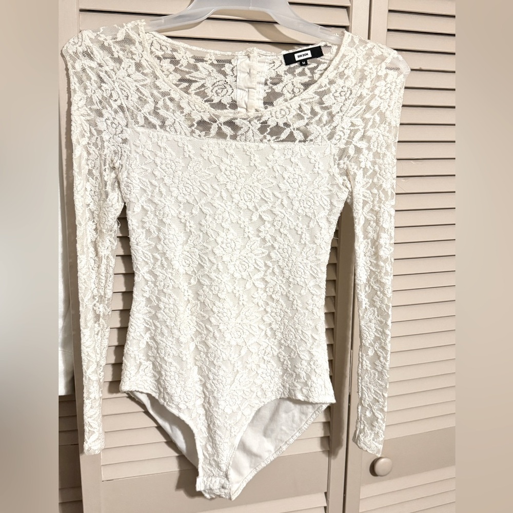 Blouse. White. Lace. Chiffon. With buttons in the back. And snaps at the bottom.